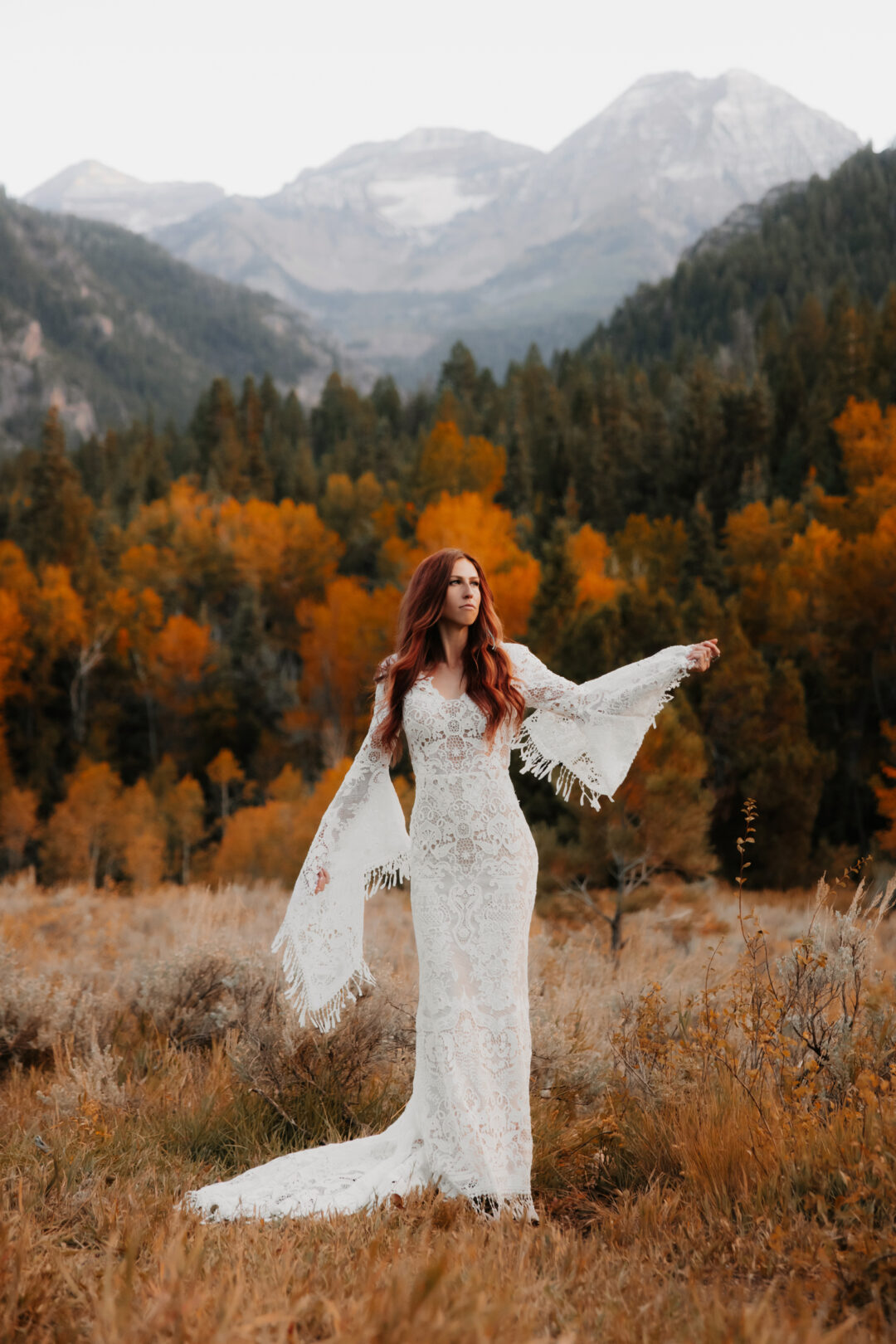 Bride dancing in her lace wedding dress at tibble fork reservoir