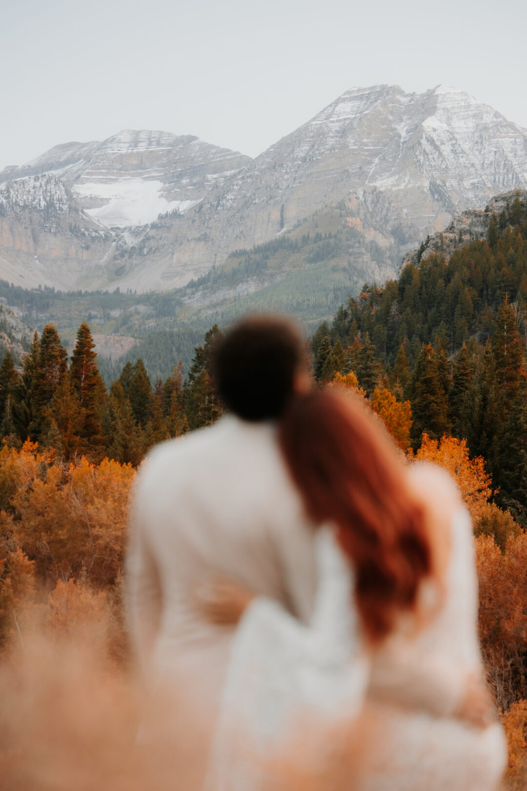 Couple looking at Utah fall colors during their wedding photography session