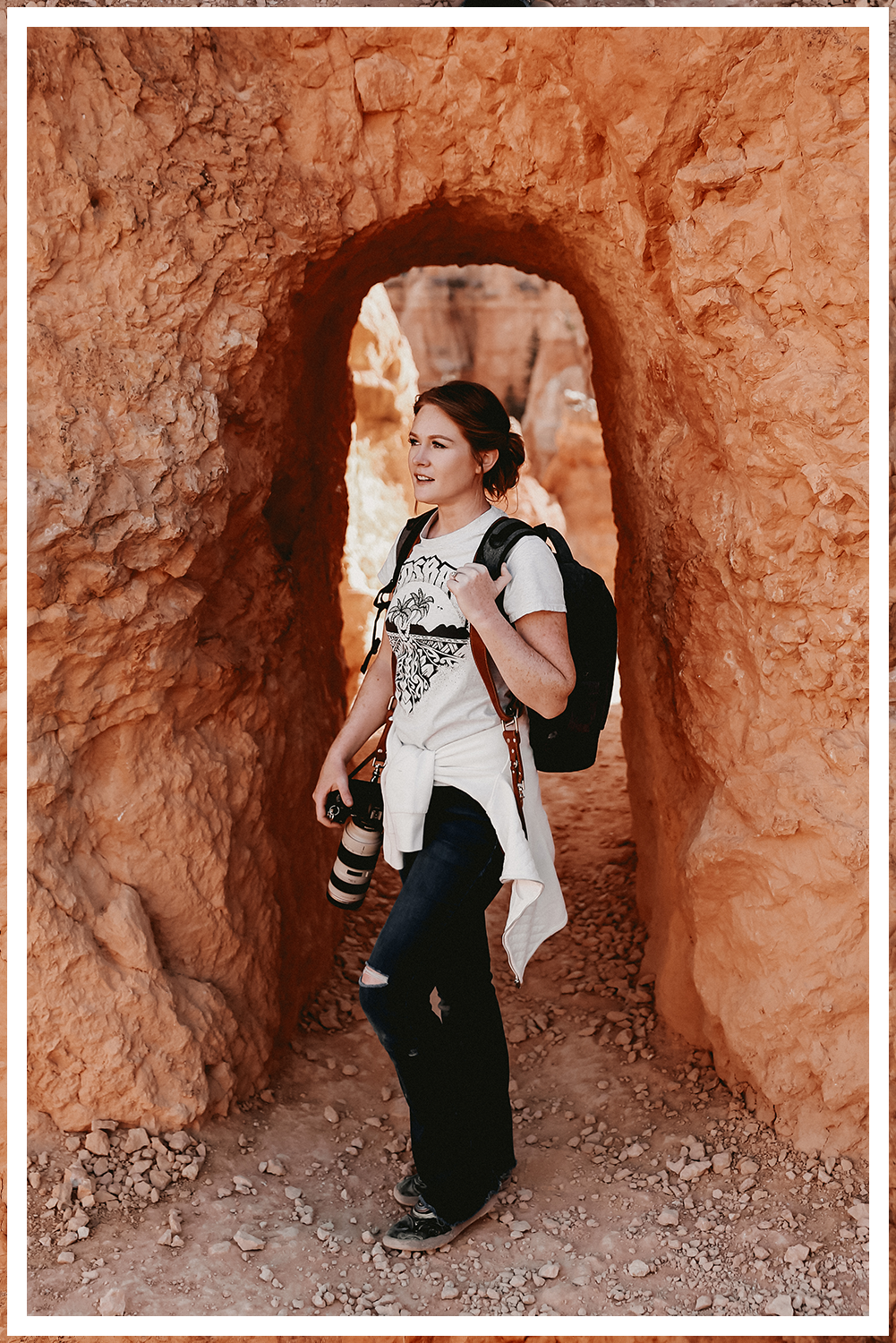 A bride and groom in ornate Indian clothing with a vast desert landscape with stormy skies and lighting with dreamy sunset lighting.