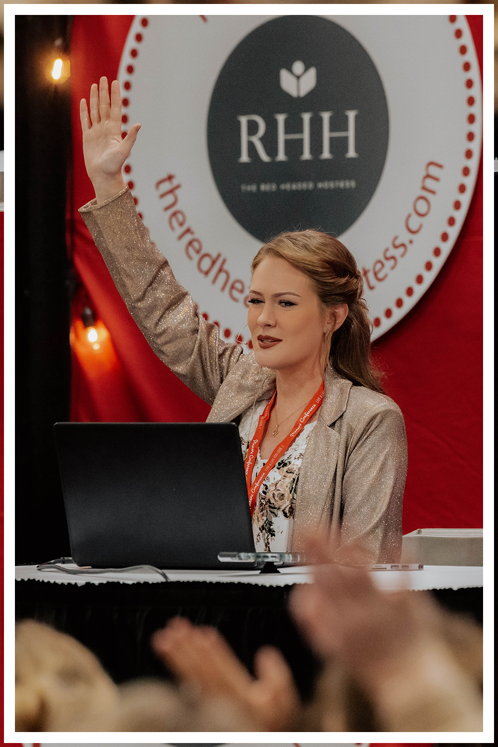 A wedding couple in Dead Horse State Park standing on a large stack of deep red stone at sunset with cinematic hazy lighting near the edge of the cliff.